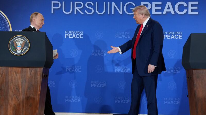 ANCHORAGE, ALASKA - AUGUST 15: U.S. President Donald Trump (R) reaches out to shake hands with Russian President Vladimir Putin at the end of a press conference at Joint Base Elmendorf-Richardson on August 15, 2025 in Anchorage, Alaska. The two leaders are meeting for peace talks aimed at ending the war in Ukraine. (Photo by Andrew Harnik/Getty Images)