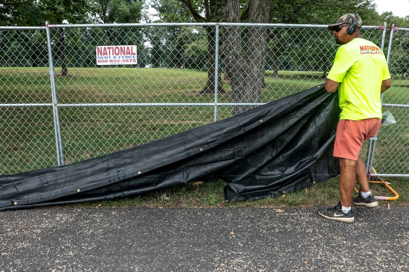 Workers put up black mesh over fencing encircling the Reflecting Pool in Washington, D.C. on July 10, 2026.