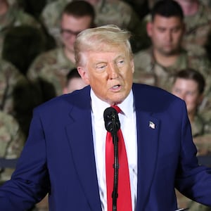 President Trump speaks while Michigan Air National Guard troops stand behind him.