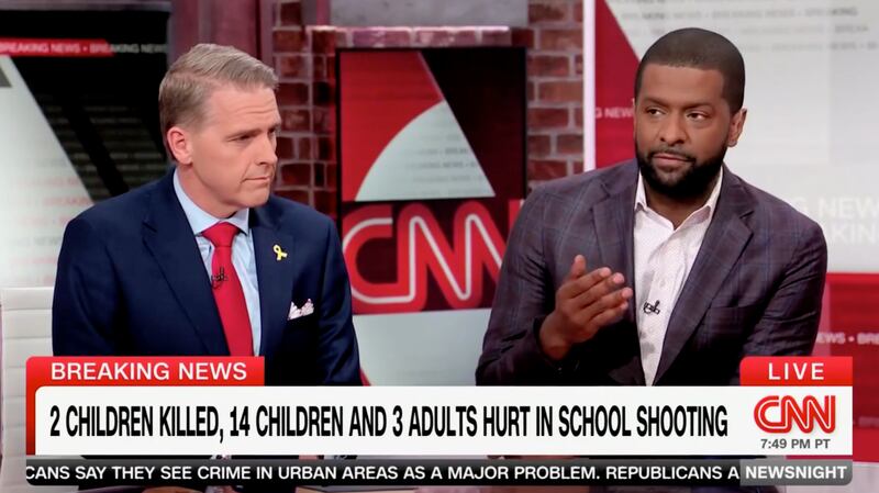 Scott Jennings (left) listens while Bakari Sellers (right) speaks on the set of News Night.