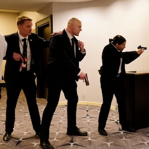 Federal agents draw their guns out after an incident at the annual White House Correspondents Association Dinner April 25, 2026 in Washington, DC. According to reports, President Donald Trump, along with other government officials, were evacuated from the Washington Hilton after what sounded like gun fire.