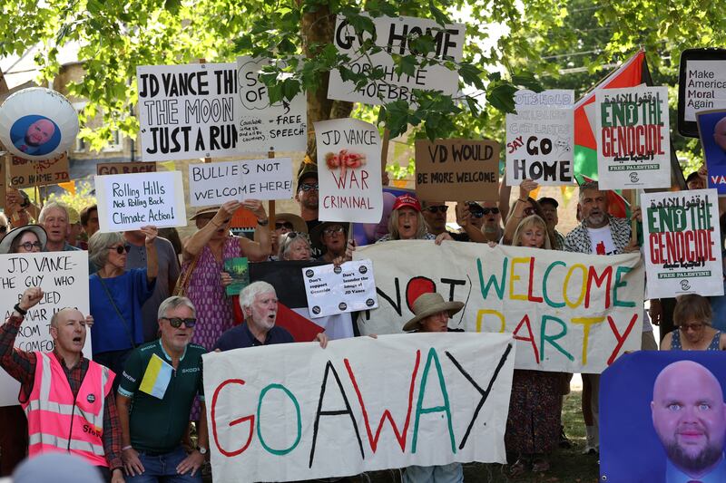 Protestors pose with placards at a "Vance Not Welcome Party" in  Charlbury.