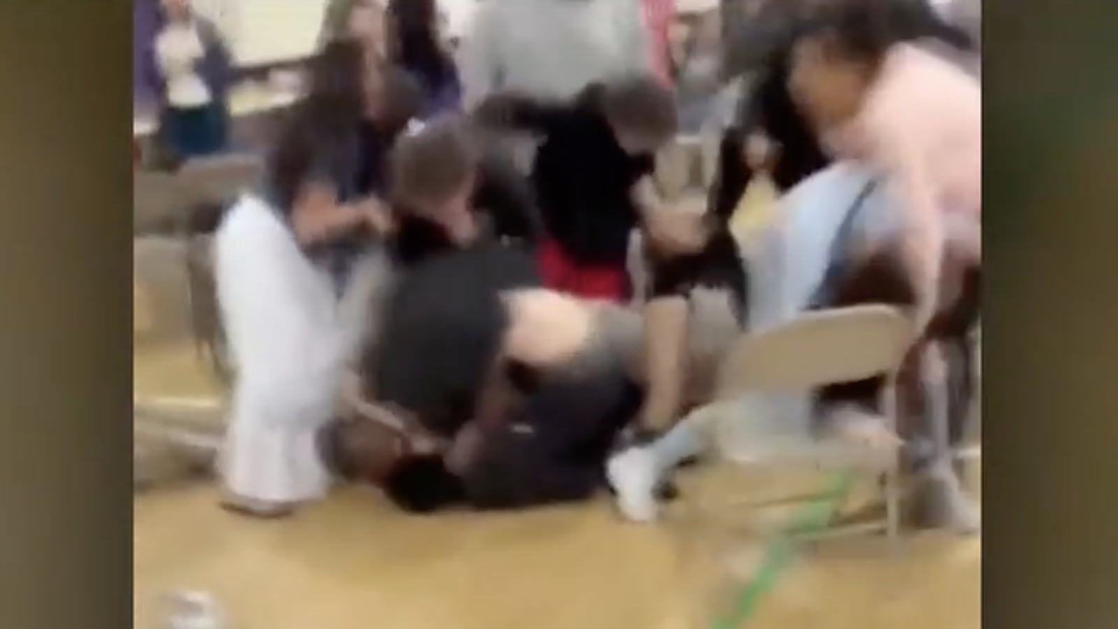 A local TV news package shows a brawl amongst parents in a school gym.