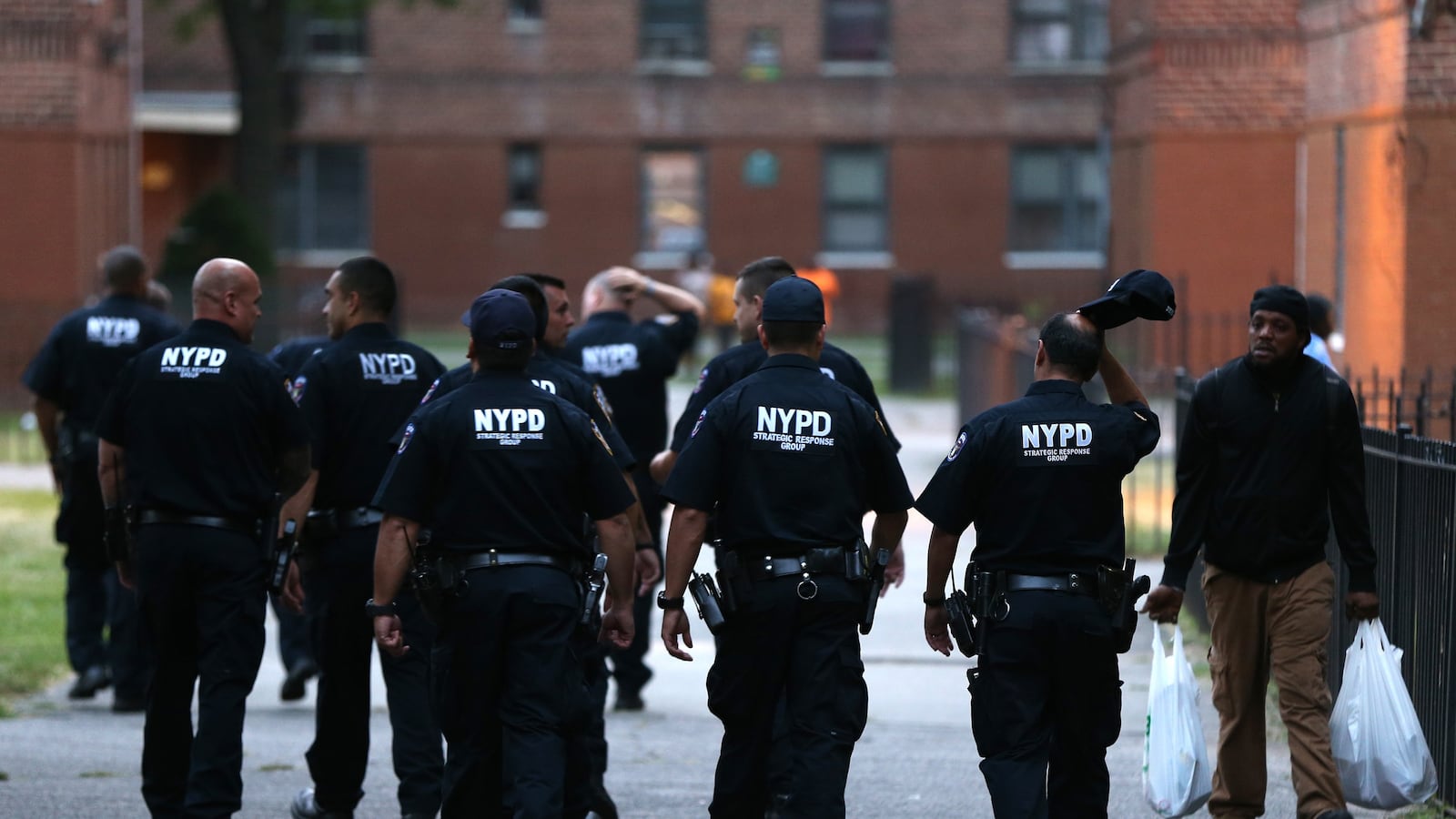 Members of a New York Police Department \"strategic response group\" remain on scene after a shooting in the Flatbush Gardens apartment complex