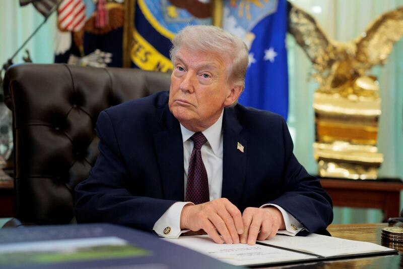 Trump at his desk with golden eagle