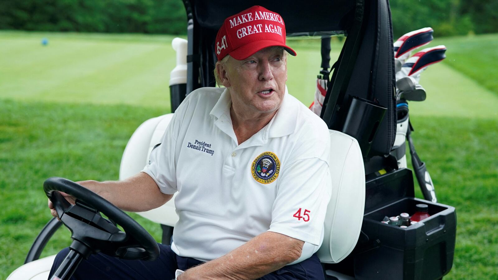 Former US President and 2024 Presidential hopeful Donald Trump drives a golf cart during the Official Pro-Am Tournament ahead of the LIV Golf Invitational Series event at Trump National Golf Club Bedminster in Bedminster, New Jersey, on August 10, 2023. The LIV Golf Invitational Bedminster begins on August 11.