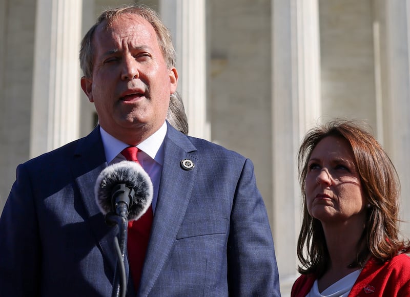 Texas Attorney General Ken Paxton and his wife, State Senator Angela Paxton, speaks to anti-abortion supporters outside the U.S. Supreme Court following arguments over a challenge to a Texas law that bans abortion after six weeks in Washington, U.S., November 1, 2021.