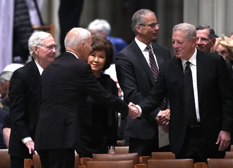 Sen. Mitch McConnell and his wife, Elaine Chao, watch on as Al Gore greets former President Joe Biden.