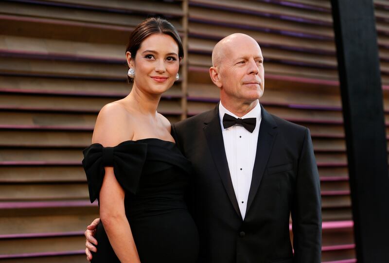 Actor Bruce Willis (R) and his wife Emma Heming arrive at the 2014 Vanity Fair Oscars Party in West Hollywood,