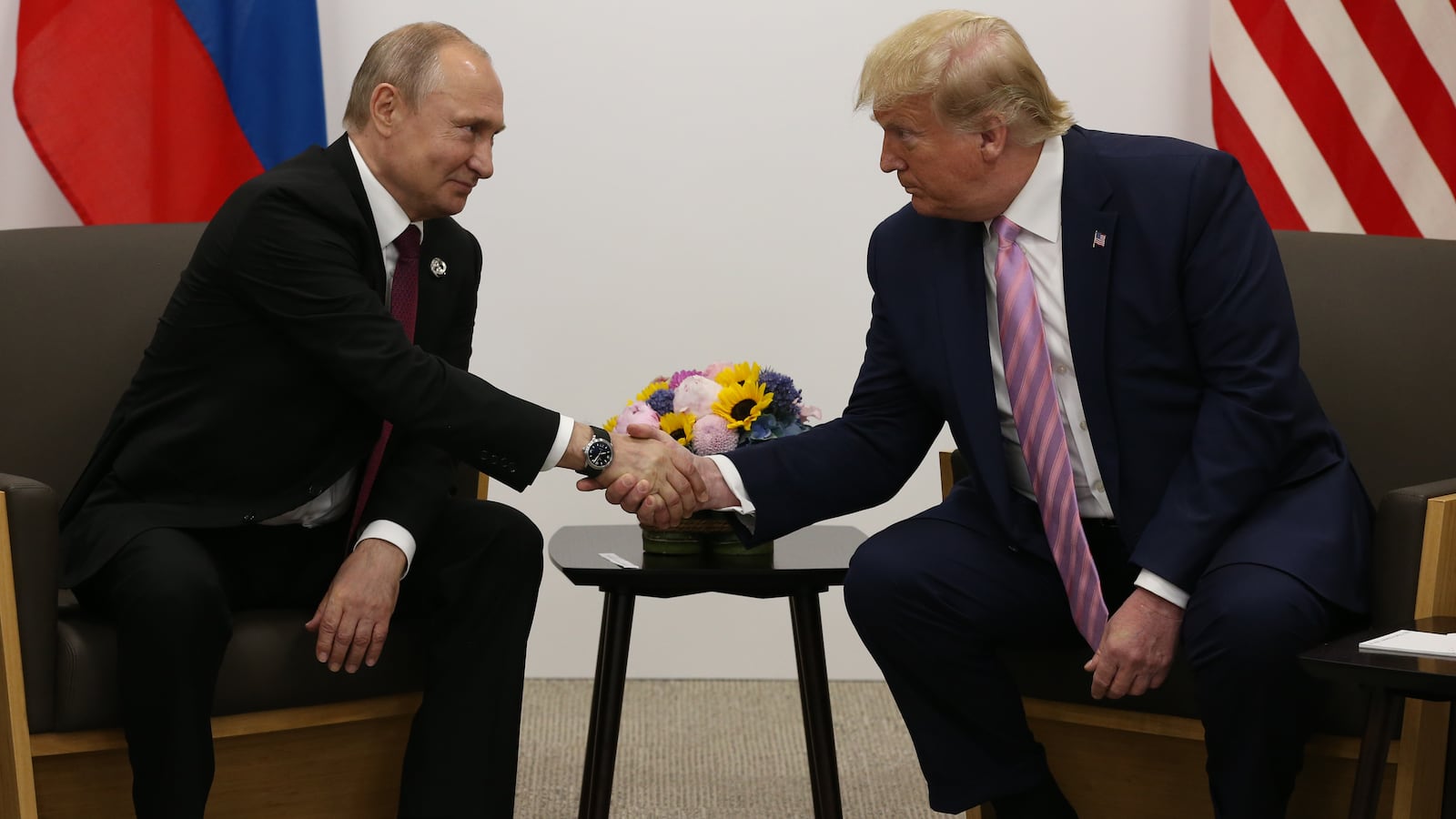 U.S. President Donald Trump (R) greets Russian President Vladimir Putin (L) during their bilateral meeting at the G20 Osaka Summit 2019, in Osaka, Japan
