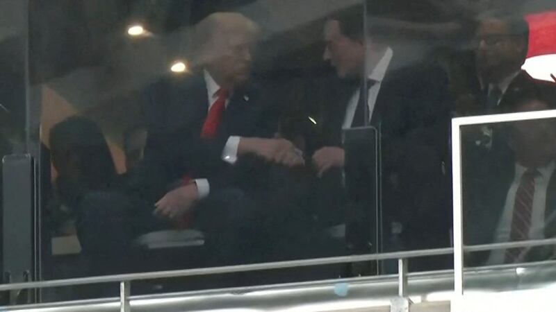 A still image from video shows U.S. President Donald Trump and Tesla CEO Elon Musk shaking hands in a skybox at State Farm Stadium during the memorial service for slain conservative commentator Charlie Kirk, in Glendale, Arizona, U.S., September 21, 2025.  Reuters TV via REUTERS