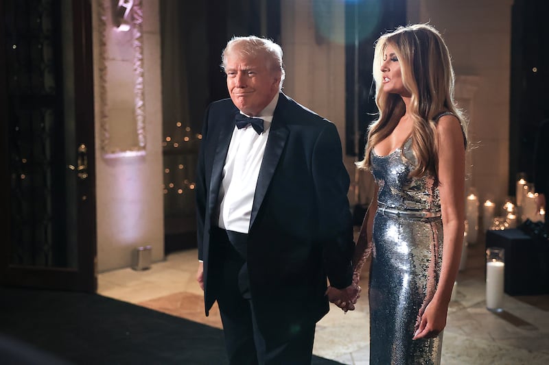 U.S. President Donald Trump and first lady Melania Trump arrive for a New Year’s Eve event at his Mar-a-Lago home on December 31, 2025 in Palm Beach, Florida. The president addressed guests and celebrated the arrival of 2026.