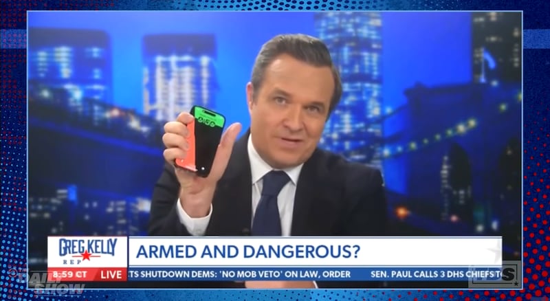 Greg Kelly on Newsmax talking about his phone screensaver, clip shown on The Daily Show.