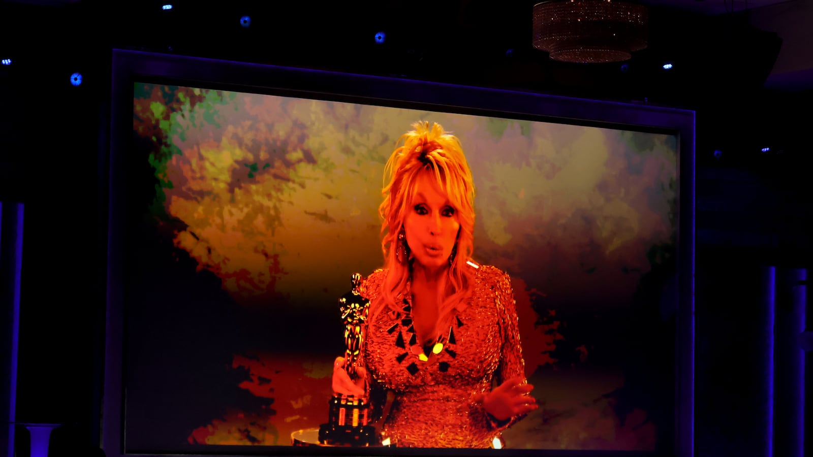 HOLLYWOOD, CALIFORNIA - NOVEMBER 16: Dolly Parton accepts an Academy Honorary Award via video during the 16th Governors Awards at The Ray Dolby Ballroom on November 16, 2025 in Hollywood, California. (Photo by Kevin Winter/Getty Images)