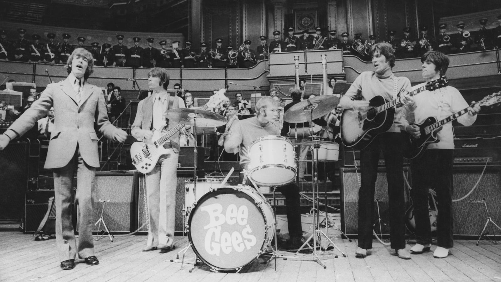 The Bee Gees rehearse with the RAF Apprentices Marching Band and a sixty-piece orchestra for their upcoming concert at the Royal Albert Hall, London, 27th March 1968.
