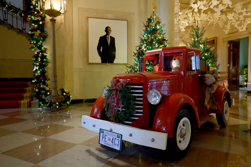 A vintage red truck sits in the Grand Foyer during a media preview of the 2024 holiday decorations at the White House on December 02, 2024 in Washington, DC. The theme for this year's White House holiday decorations is “Season of Peace and Light.”