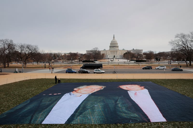 A photo of U.S. President Donald Trump and convicted sex offender Jeffrey Epstein is unfurled on the National Mall near the U.S. Capitol by the political protest organizations Everyone Hates Elon and Glasgow Actions Team on December 15, 2025 in Washington, DC.