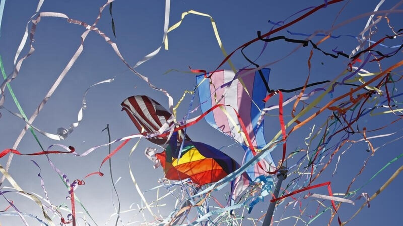 Flags promoting LGBTQ+ and transgender pride fly above the stadium as streamers are shot into the air before the game between the San Francisco Giants and the Chicago Cubs.
