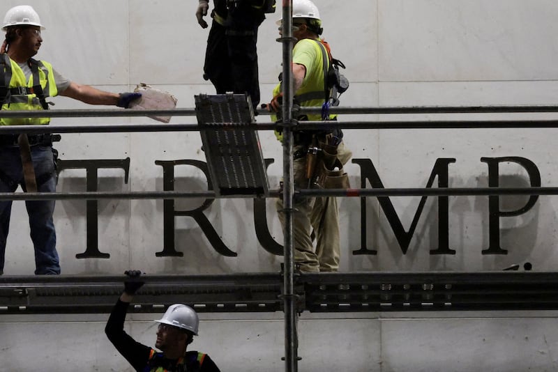 Workers prepare scaffolding ahead of removing lettering from the facade of the John F. Kennedy Memorial Center for the Performing Arts, following a federal judge’s order to remove President Donald Trump's name from the institution in Washington, D.C., on June 13, 2026.