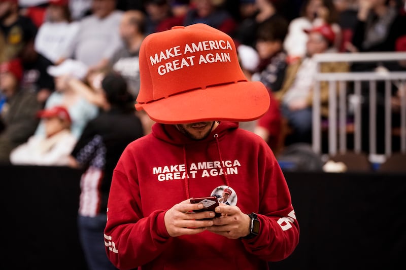 MANCHESTER, NH - FEBRUARY 10: A supporter of U.S. President Donald Trump wears an oversize "Make America Great Again Hat" as he waits for the start of a "Keep America Great" rally at Southern New Hampshire University Arena on February 10, 2020 in Manchester, New Hampshire. New Hampshire will hold its first in the national primary on Tuesday.