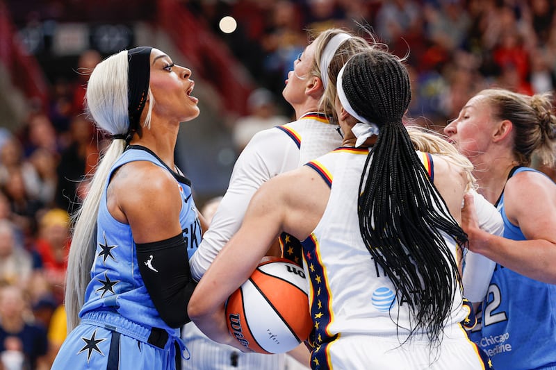 Indiana Fever guard Sophie Cunningham (8) fights with Chicago Sky guard DiJonai Carrington (7) after she was fouled during the first half at United Center.