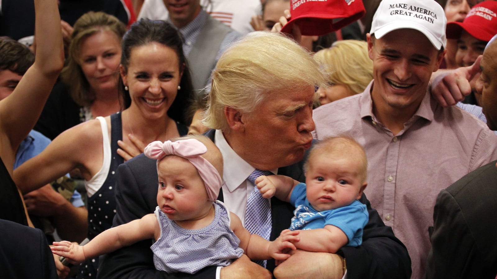 COLORADO SPRINGS, CO - JULY 29: Republican presidential nominee Donald Trump kisses three-month-old Kellen Campbell, of Denver, right, and holds six-month-old Evelyn Keane, of Castel Rock, Colo., after Trump's speech at the Gallogly Event Center on the campus of the University of Colorado on July 29, 2016 in Colorado Springs, Colorado. (Photo by Joe Mahoney/Getty Images)