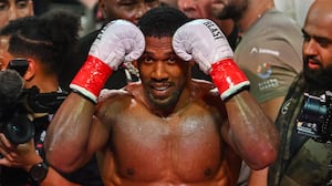 British boxer Anthony Joshua celebrates after defeating US boxer and influencer Jake Paul (off frame) in a non-title heavyweight bout at the Kaseya Center in Miami, Florida, on December 19, 2025. (Photo by Giorgio VIERA / AFP via Getty Images)