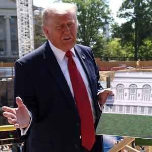 U..S. President Donald Trump shows images of the concept at the site of ongoing construction of the planned White House ballroom in Washington, D.C., U.S., May 19, 2026.