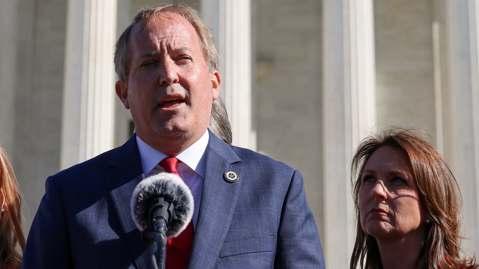 Texas Attorney General Ken Paxton flanked by his wife, State Senator Angela Paxton