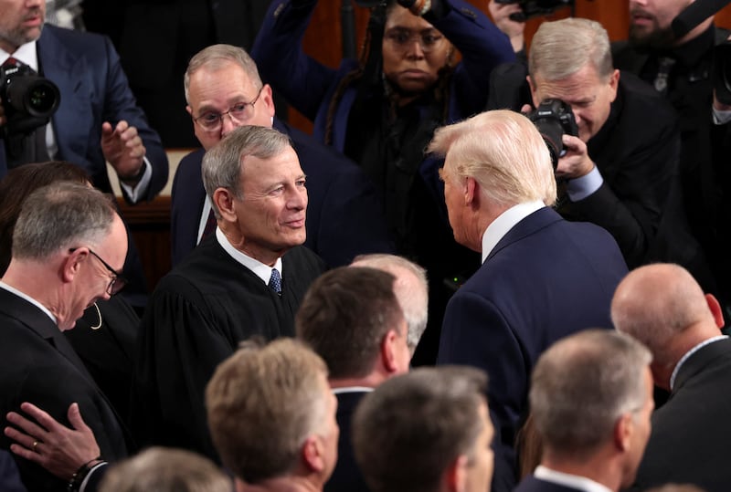 U.S. President Donald Trump talks to Chief Justice of the Supreme Court John Roberts on the day of his speech to a joint session of Congress, in the House Chamber of the U.S. Capitol in Washington, D.C., U.S., March 4, 2025. REUTERS/Kevin Lamarque