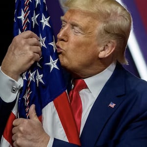 Donald Trump kisses a flag.