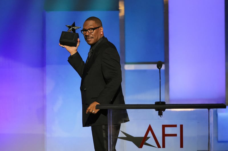 Eddie Murphy gestures on the stage after winning at the 51st AFI Life Achievement Award tribute gala at the Dolby Theatre in Los Angeles, California, U.S., April 18, 2026. REUTERS/Daniel Cole