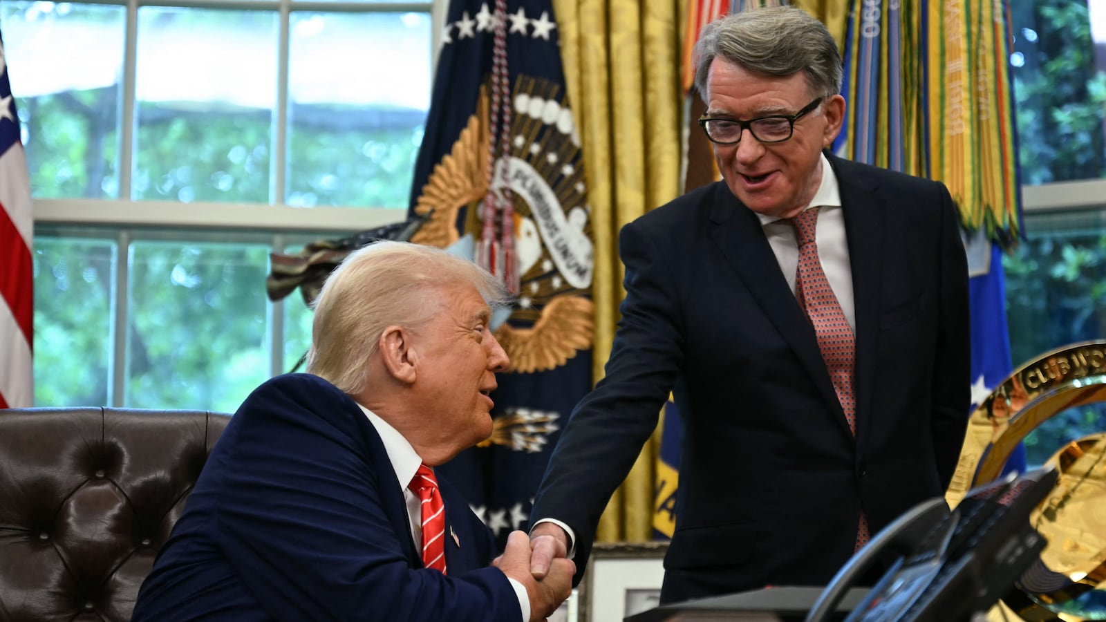 US President Donald Trump shakes hands with British ambassador to the United States Peter Mandelson after making a trade announcement in the Oval Office of the White House in Washington, DC, on May 8, 2025.