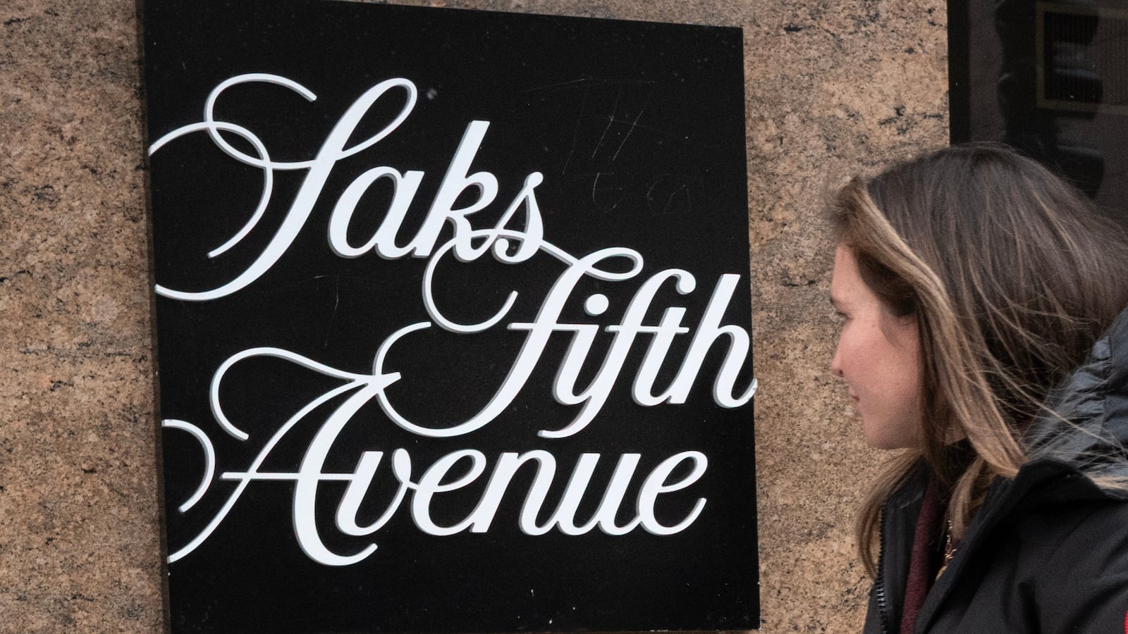 CHICAGO, ILLINOIS - DECEMBER 30: Pedestrians walk past a Saks Fifth Avenue store on December 30, 2025 in Chicago, Illinois. Recent reports indicate that Saks Global Enterprises, the parent corporation of Saks Fifth Avenue, may file for Chapter 11 bankruptcy as they face a more than $100 million debt payment due at the end of December. (Photo by Scott Olson/Getty Images)