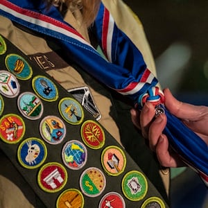 A scout receives her blue Eagle Scout neckerchief during a ceremony recognizing the inaugural class of female Eagle Scouts on Feb. 8, 2021, in Tacoma, Washington.