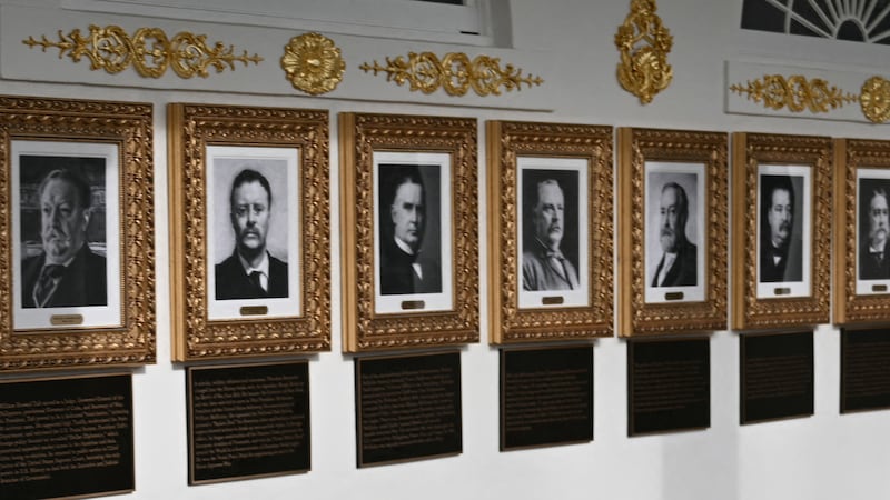 Portraits with new plaques of explanatory text are seen on the Presidential Walk of Fame.