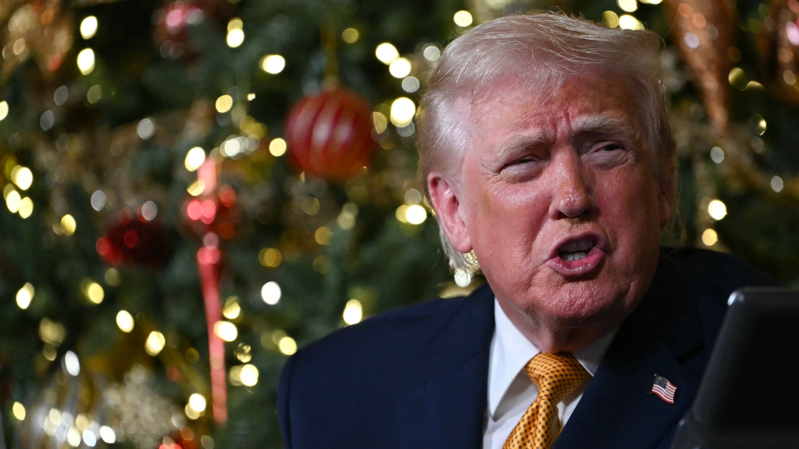 US President Donald Trump participates in NORAD Santa tracker phone calls, on Christmas Eve, from the Mar-a-lago club in Palm Beach, Florida, on December 24, 2025. (Photo by ANDREW CABALLERO-REYNOLDS / AFP via Getty Images)