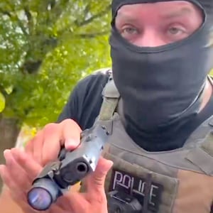 ICE Agents and one with his gun drawn.