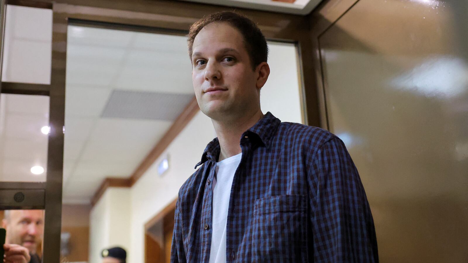 Wall Street Journal reporter Evan Gershkovich stands inside an enclosure for defendants before a court hearing to consider an appeal against his pre-trial detention on espionage charges in Moscow, Russia, Oct. 10, 2023.