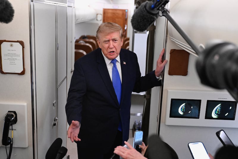 U.S. President Donald Trump speaks to the media aboard Air Force One en route to Joint Base Andrews, in Maryland, U.S., August 2, 2026.