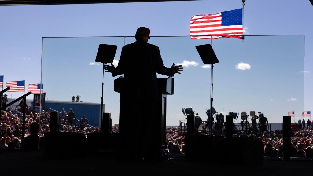 Donald Trump speaks from behind a glass protective barrier during a rally in Juneau, Wisconsin.
