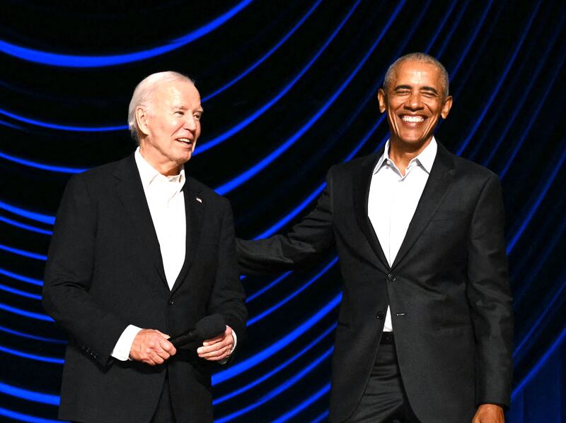 US President Joe Biden (L) laughs with former US President Barack Obama onstage during a campaign fundraiser at the Peacock Theater in Los Angeles on June 15, 2024. (Photo by Mandel NGAN / AFP)