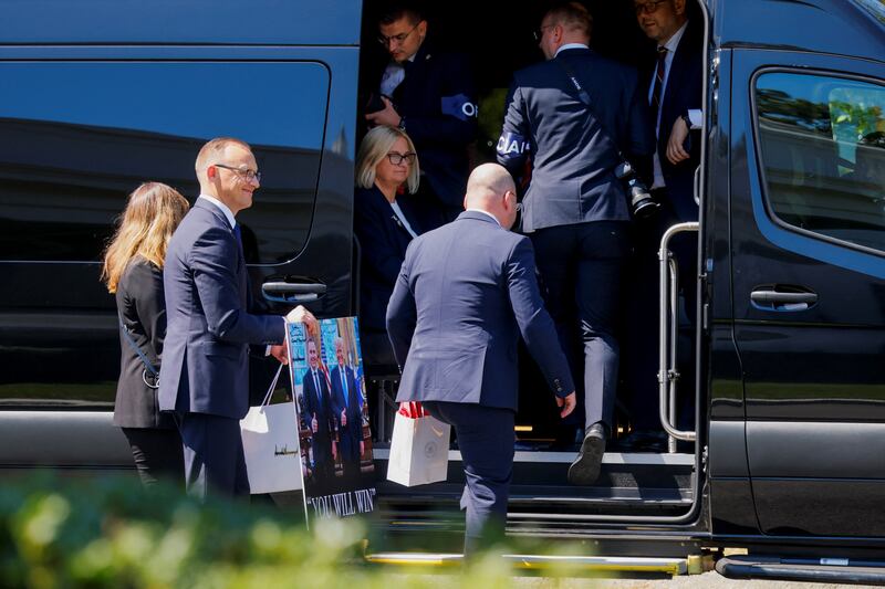 Members of the Polish delegation carry a poster with images of President of Poland Karol Nawrocki and U.S. President Donald Trump, following their meeting at the White House in Washington, D.C., U.S., September 3, 2025.  REUTERS/Brian Snyder