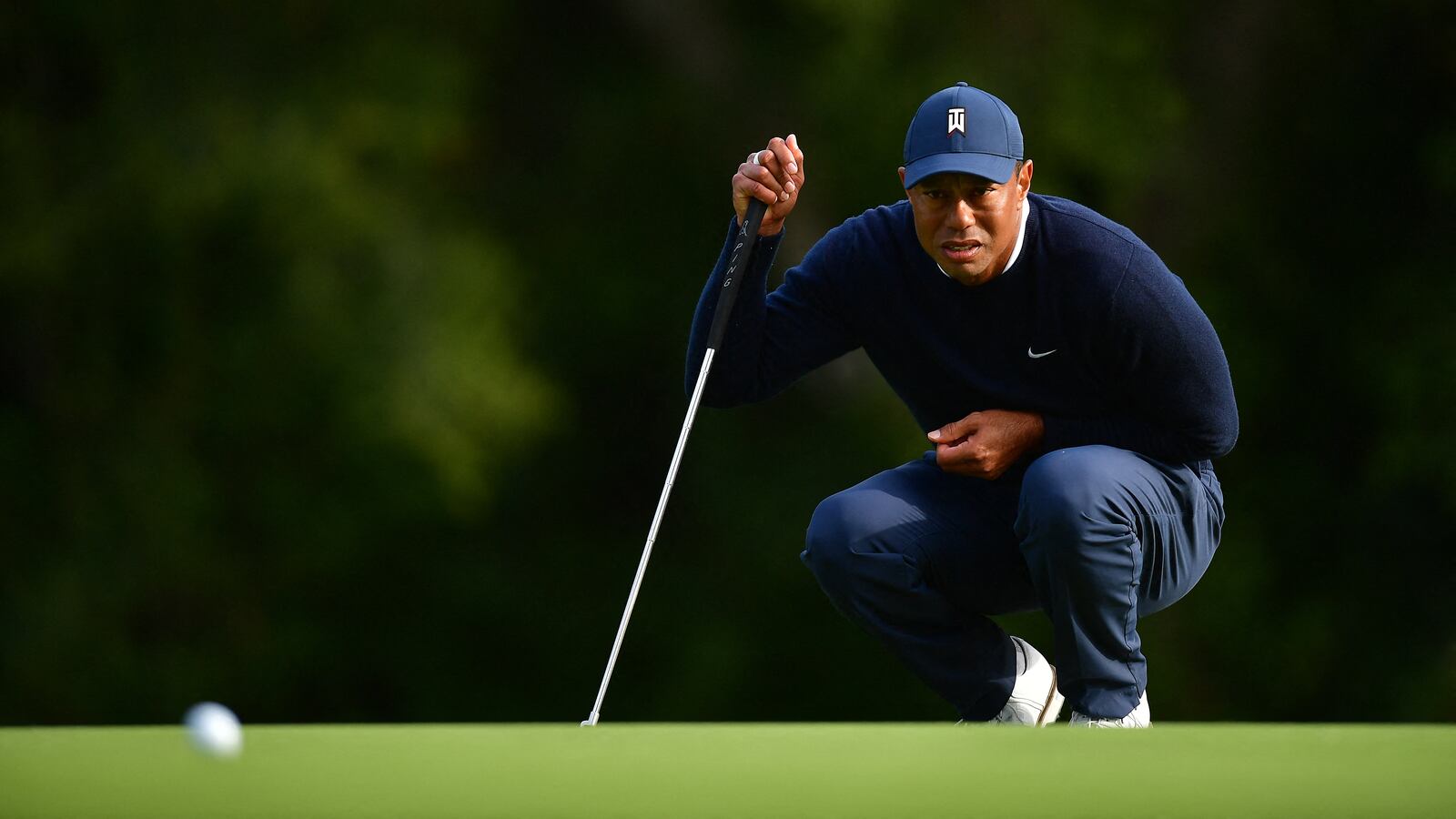 Feb 16, 2023; Pacific Palisades, California, USA; Tiger Woods lines his putt on the twelfth green during the first round of The Genesis Invitational golf tournament.