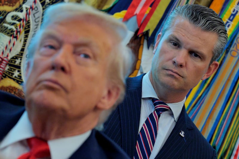 WASHINGTON, DC - AUGUST 25: U.S. Defense Secretary Pete Hegseth listens to President Donald Trump talk to journalists after signing executive orders in the Oval Office at the White House on August 25, 2025 in Washington, DC. Furthering his federal takeover of the capital city’s law enforcement, Trump signed orders ending cashless bail in the District of Columbia, mandating prosecution for people who desecrate the American flag -- including by burning it -- and other orders. (Photo by Chip Somodevilla/Getty Images)