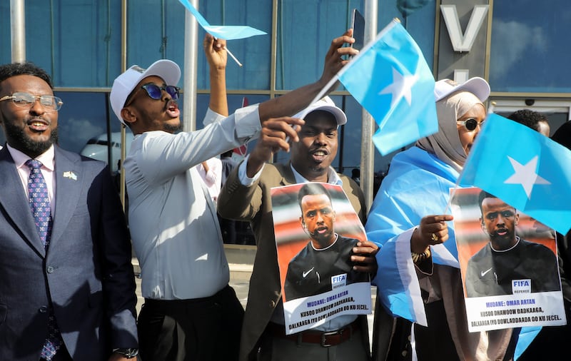 People gather to receive Somali referee Omar Abdulkadir Artan, who had been expected to officiate at matches during the 2026 FIFA World Cup but was denied entry to the United States, as he arrives at the Aden Abdulle Osman International Airport in Mogadishu, Somalia June 10, 2026. REUTERS/Feisal Omar