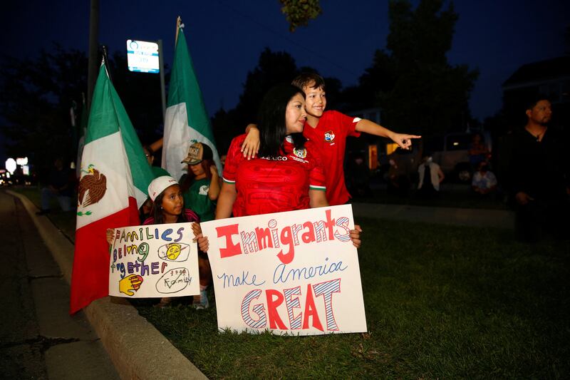 A family gathers during a candlelight vigil and protest, a day after a U.S. Immigration and Customs Enforcement officer fatally shot 38-year-old Silverio Villegas-Gonzalez during a traffic stop, which officials said he resisted, days after U.S. President Donald Trump ordered increased federal law enforcement presence and stepped-up immigration enforcement actions by the Department of Homeland Security, in Franklin, Illinois, U.S.