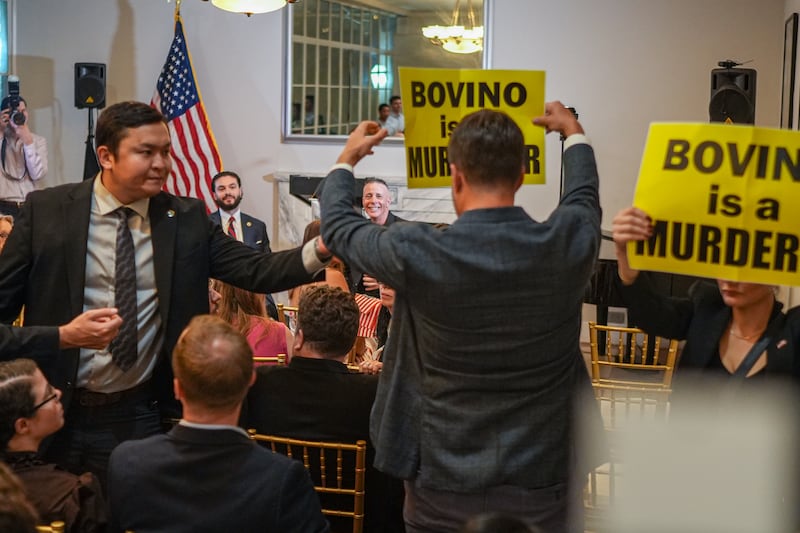 People interrupt an event in protest while former U.S. Chief Border Patrol agent Greg Bovino speaks at a New York Young Republicans event,