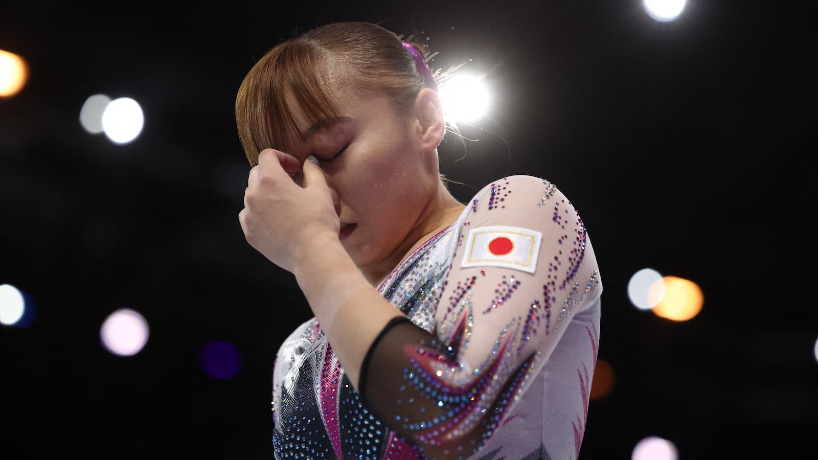 Shoko Miyata covers her face with her hand.