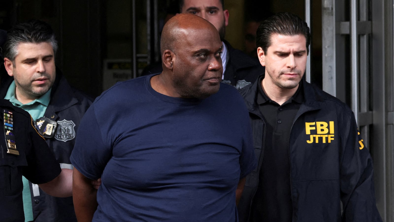 Frank James, the suspect in the Brooklyn subway shooting walks outside a police precinct